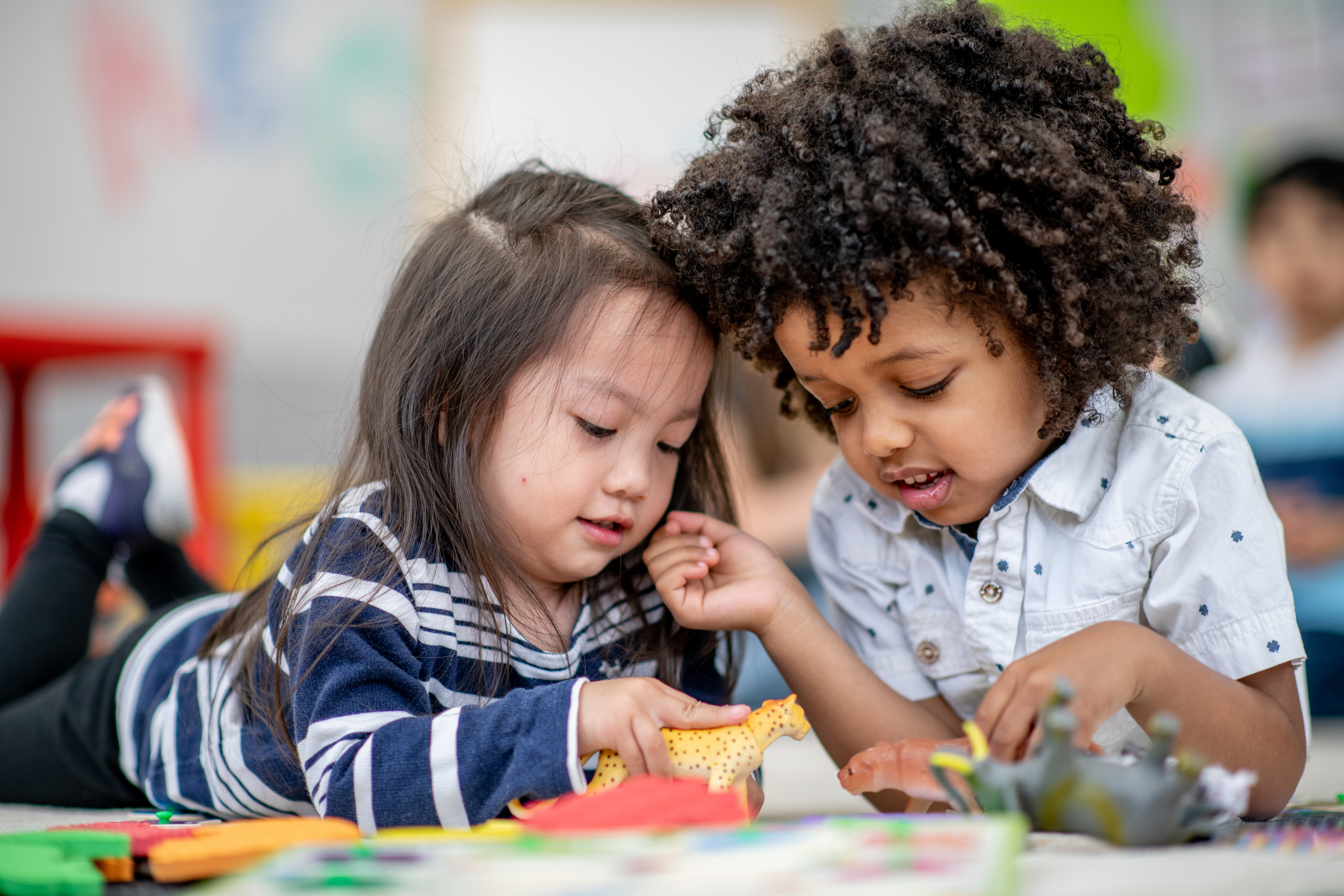 Two young children learning together