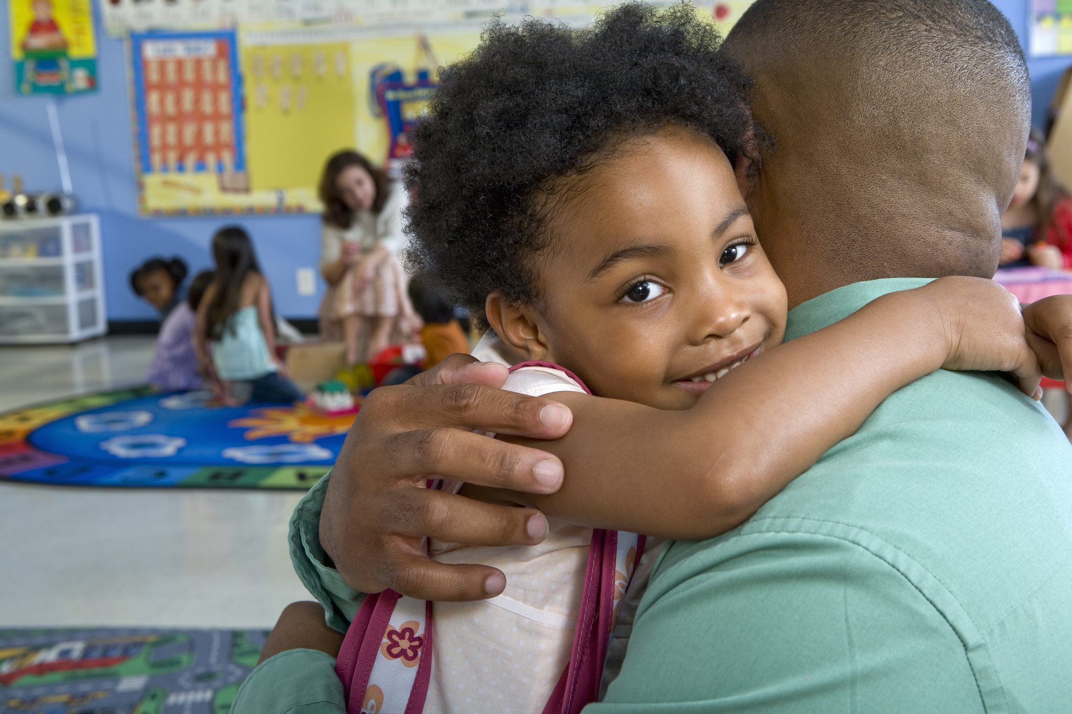 A child embracing a caregiver